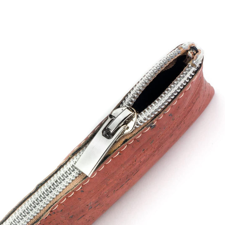 Draufsicht auf halb geöffneten Reißverschluss eines roten Schlüsseletuis aus Kork