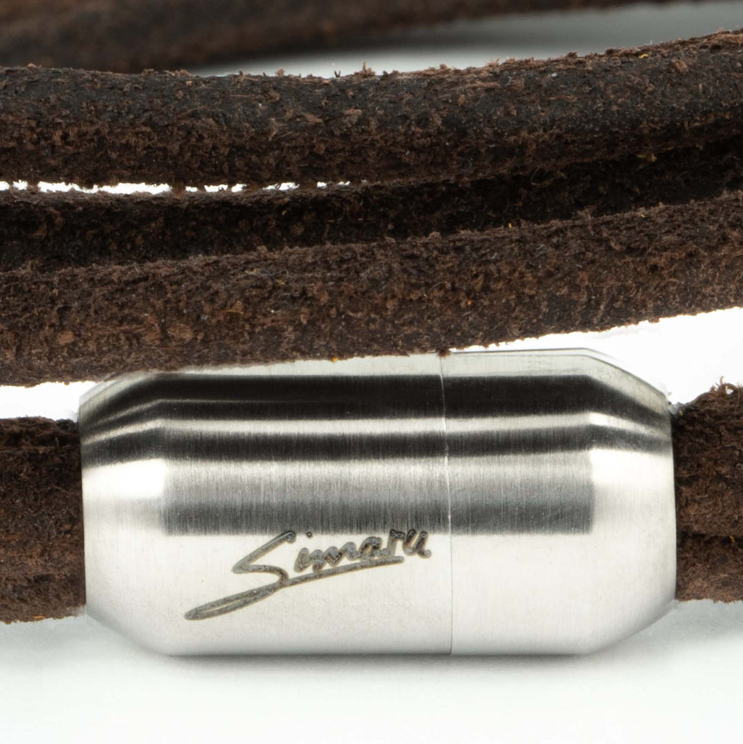 Großaufnahme silberner Magnetverschluss mit Simaru Schriftzug an dunkelbraunem Wickelarmband aus rauem Leder